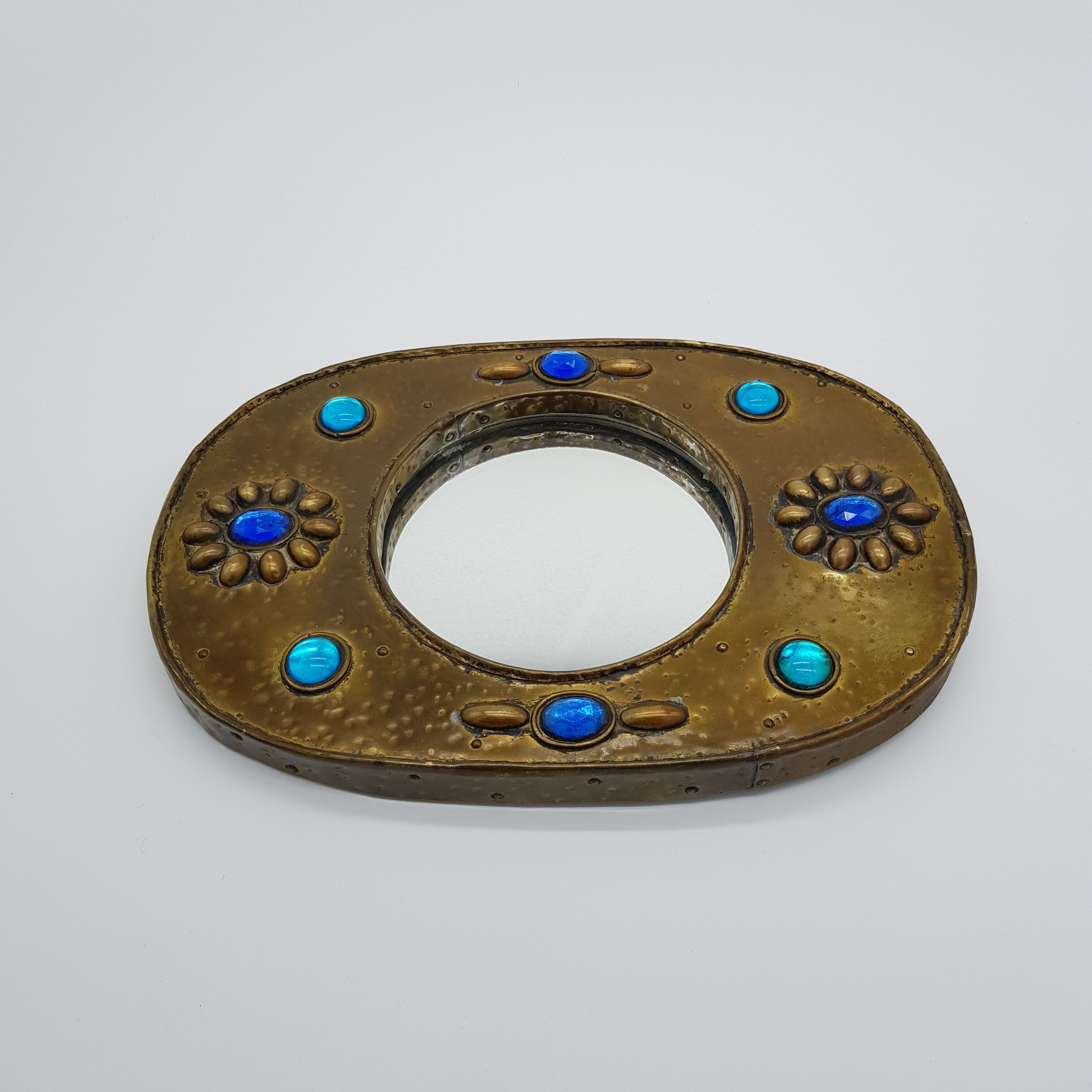Brass oval mirror and blue cabochons