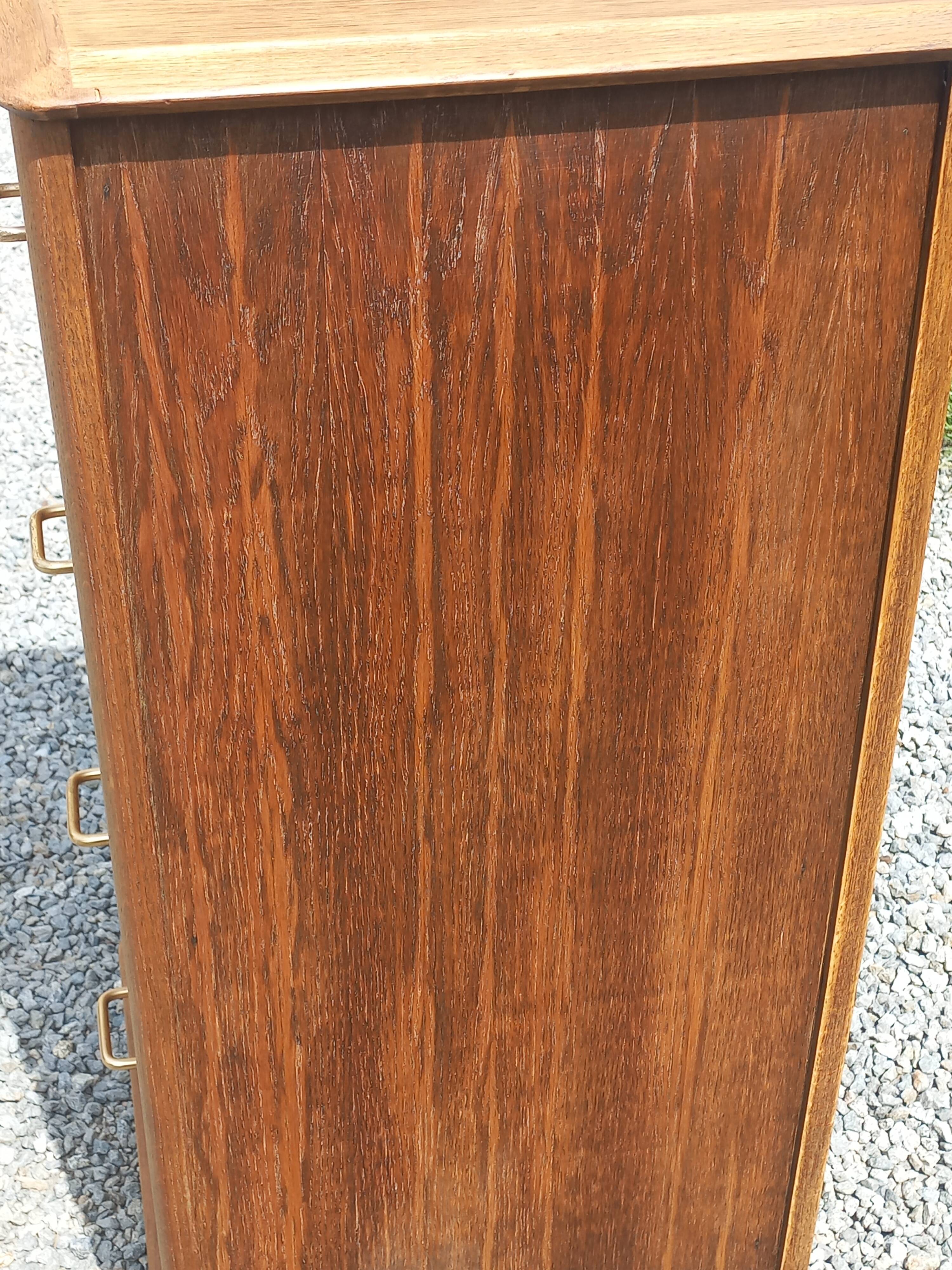 Vintage oak chest of drawers with tapered legs from the 1950s.
