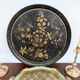 Round plateau, 19th century, painted black with fruit and grape decoration (49 cm)