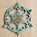 Antique round turquoise cast iron trivet.