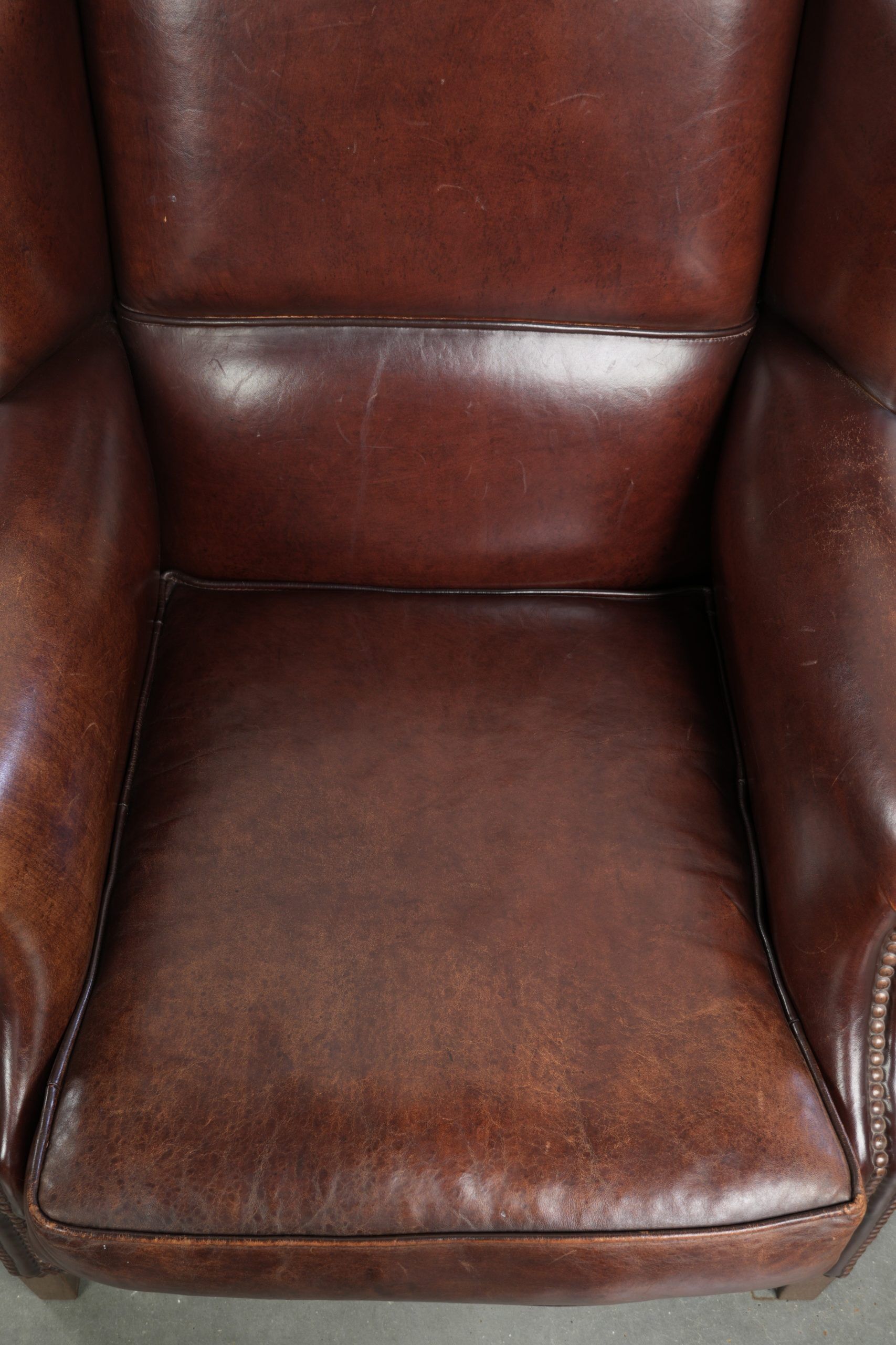 Vintage sheepskin wingback armchair with a timeless English look