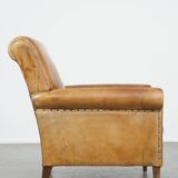 Stylish patinated vintage sheepskin armchair with a comfortable seat