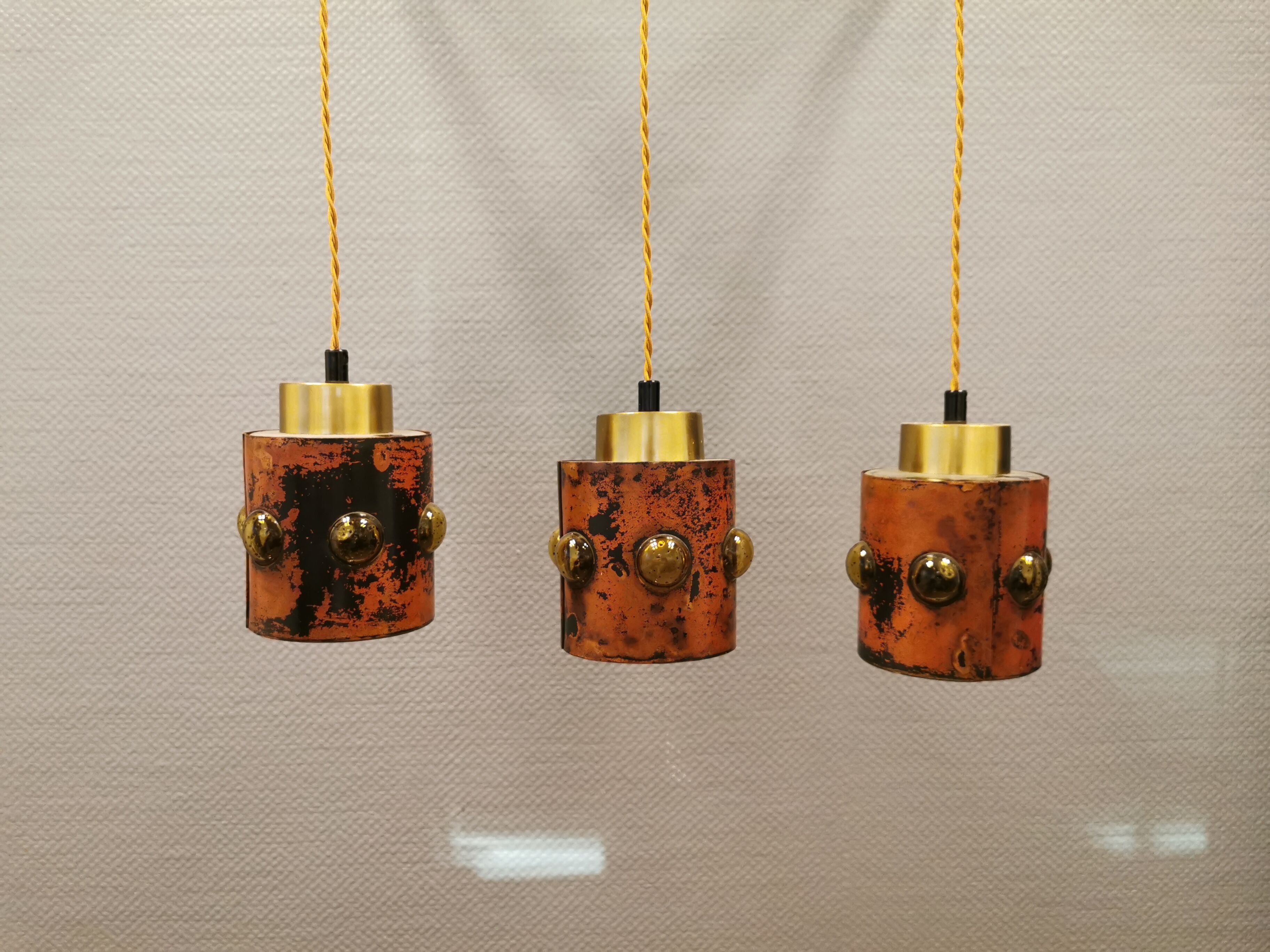 3 lamps made of copper, brass and glass.