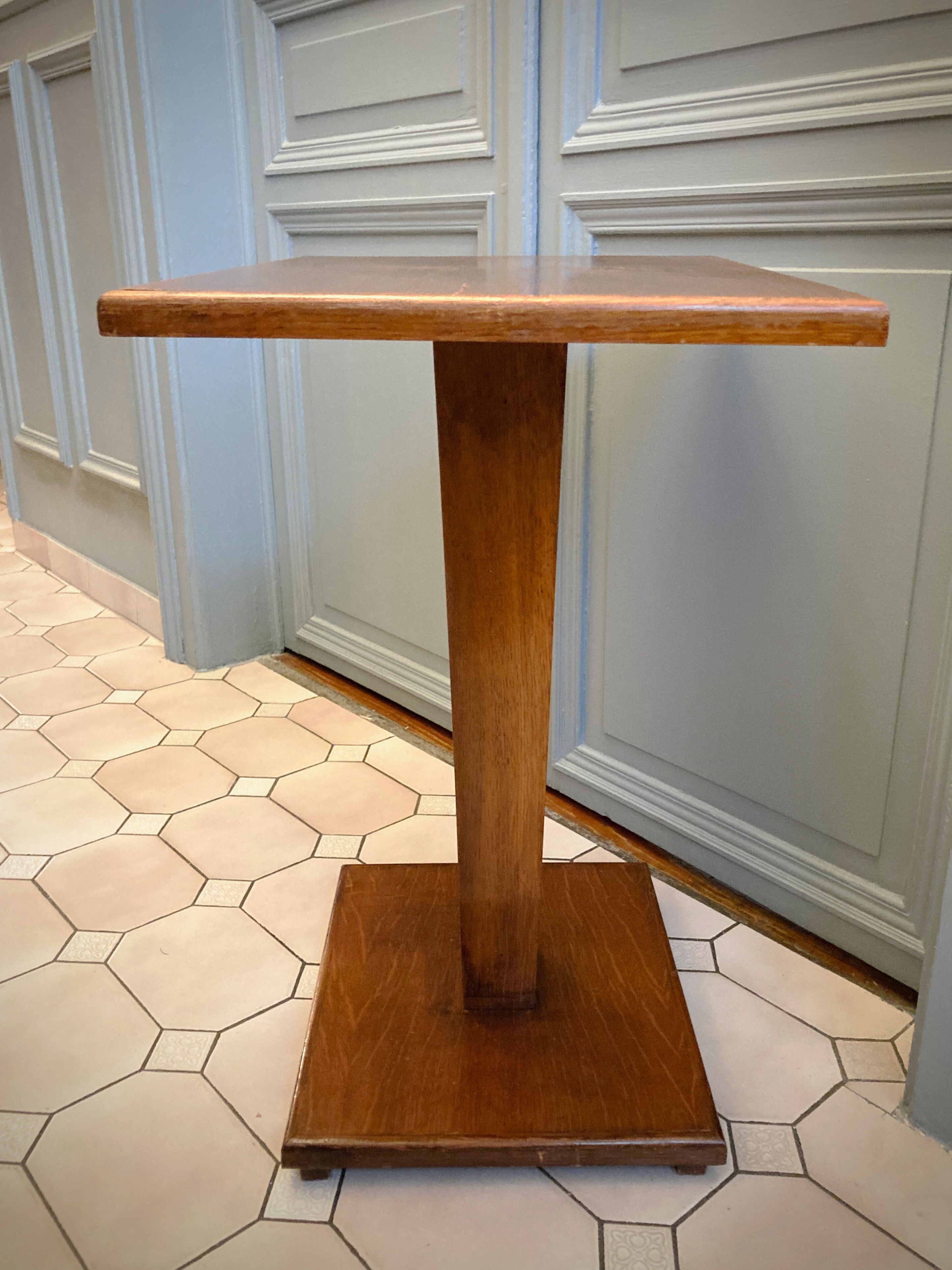 Square pedestal table with central foot 1930