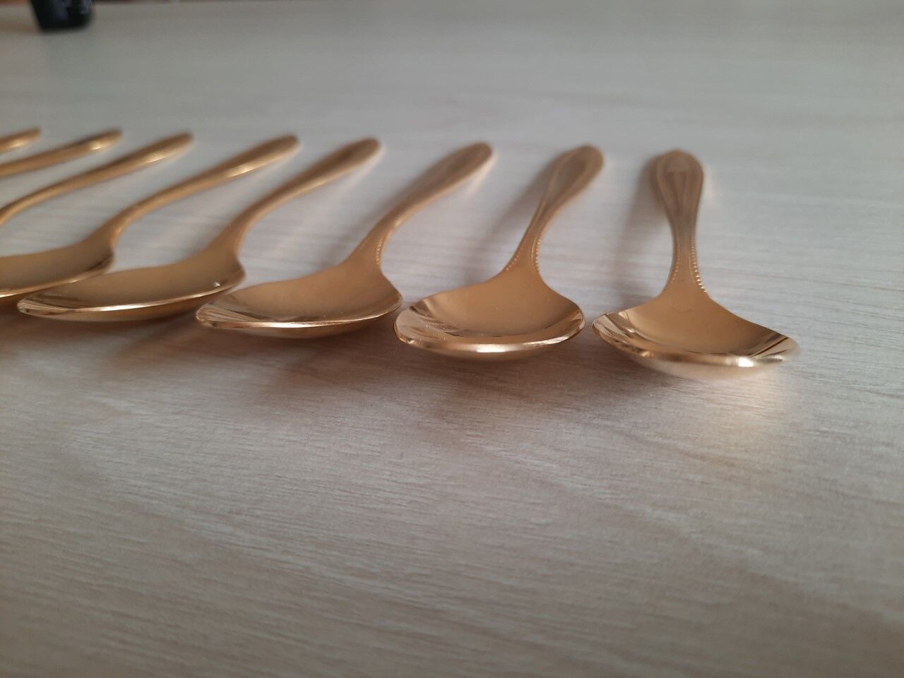 Small golden metal spoons