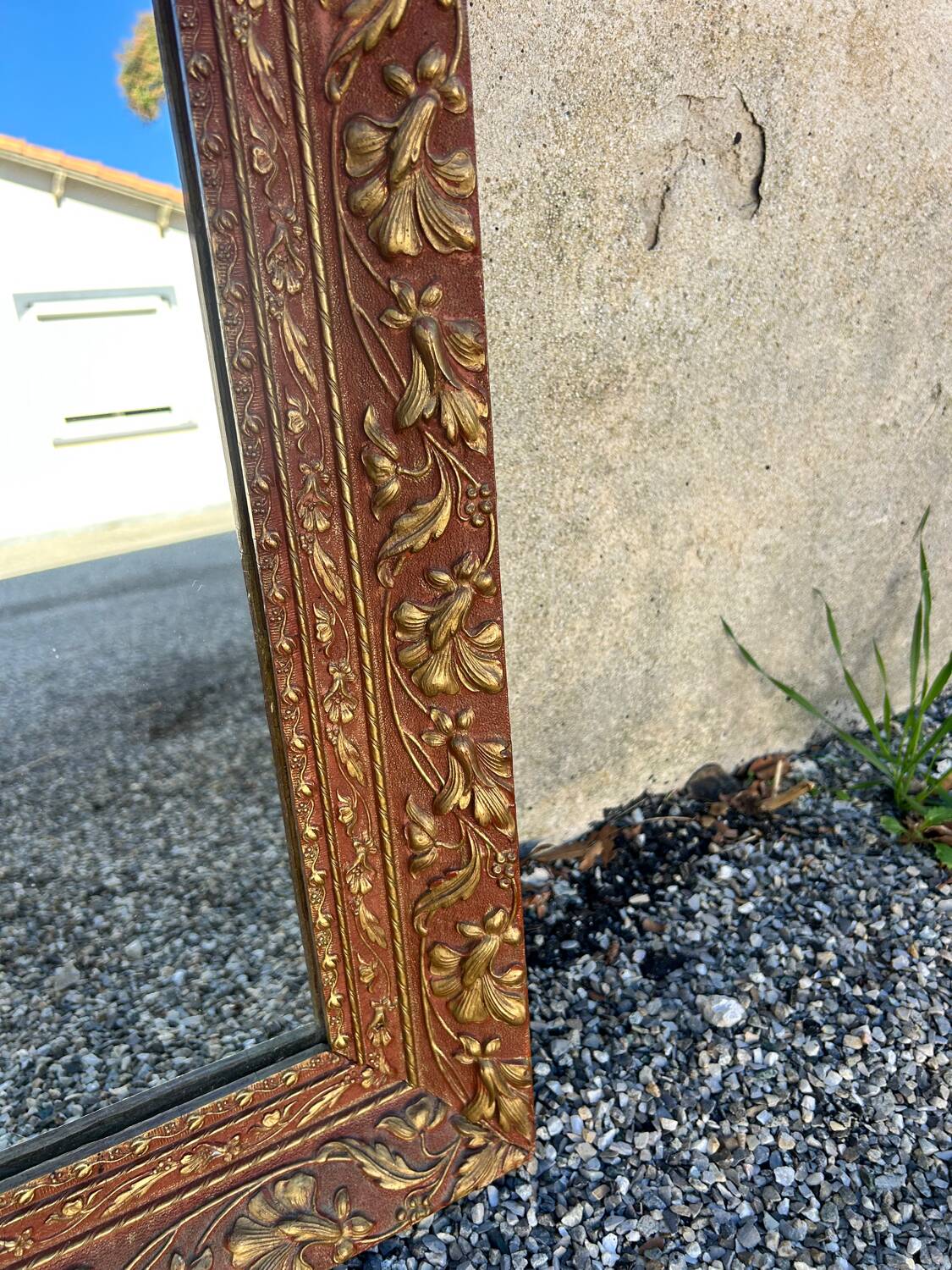 Antique mirror in patinated gilt wood
