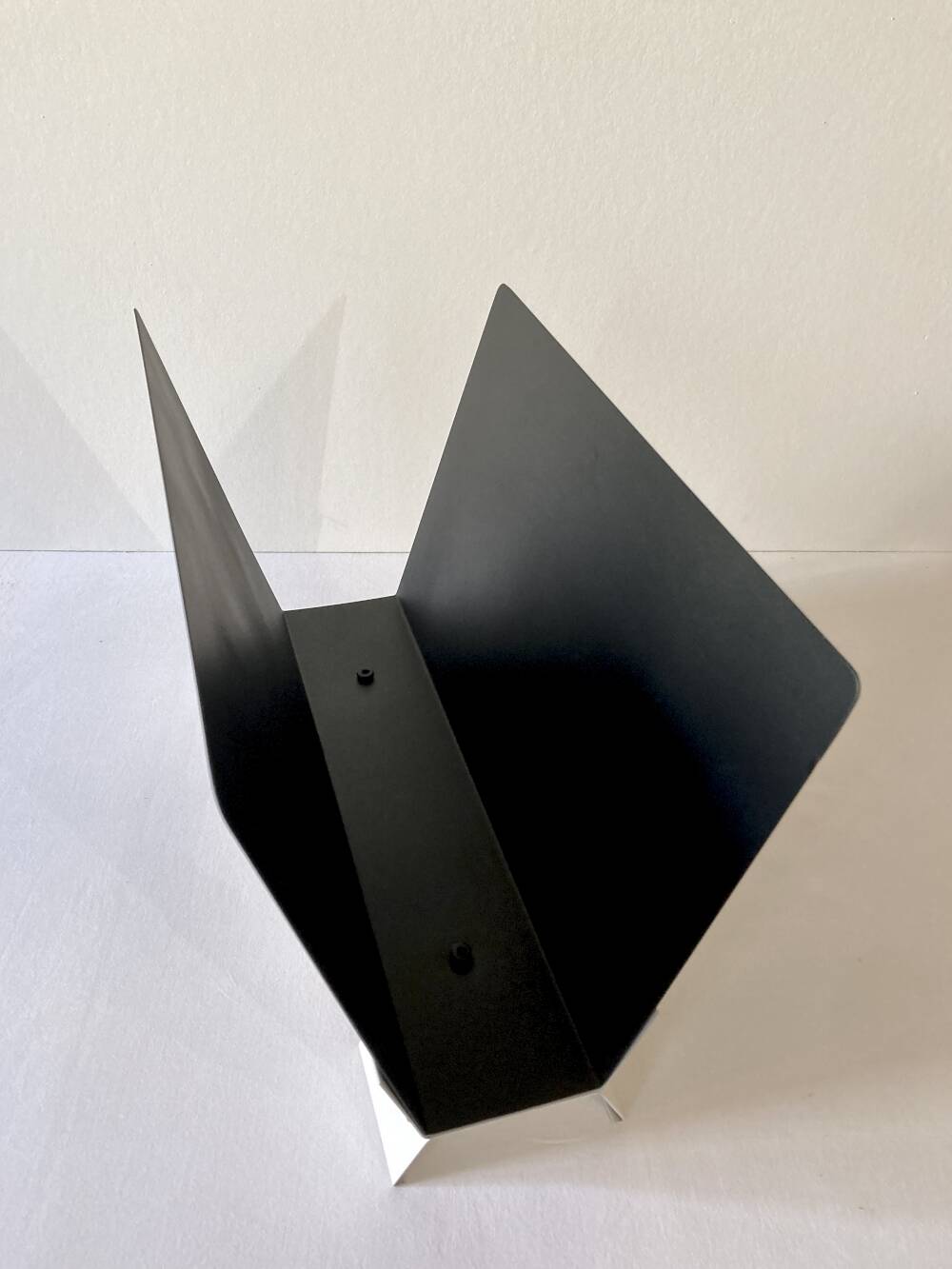 Black and cream metal magazine rack, 1950s.