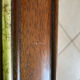 Vintage bevelled wall mirror in stained wood and brass