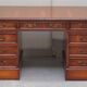 Partner desk with double pedestal in burr yew wood with decorated top.
