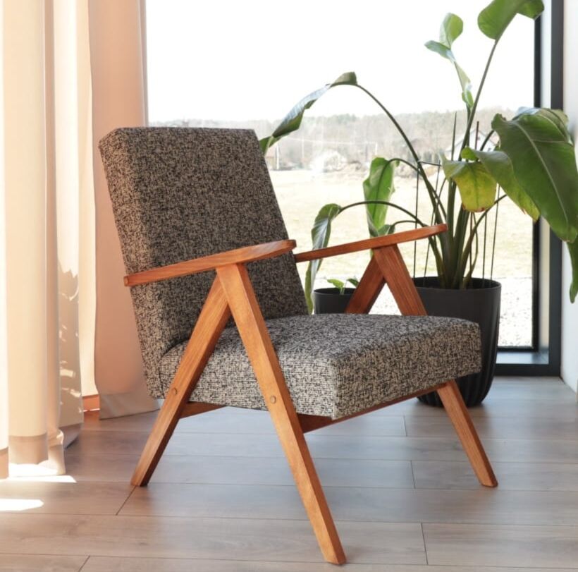 Vintage design armchair in mixed black fabric, walnut-coloured wood.
