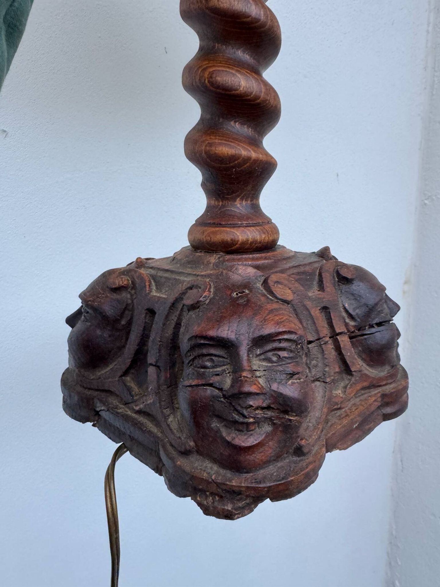 Sculpted wooden lamp with faces, antique.