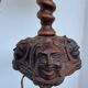 Sculpted wooden lamp with faces, antique.