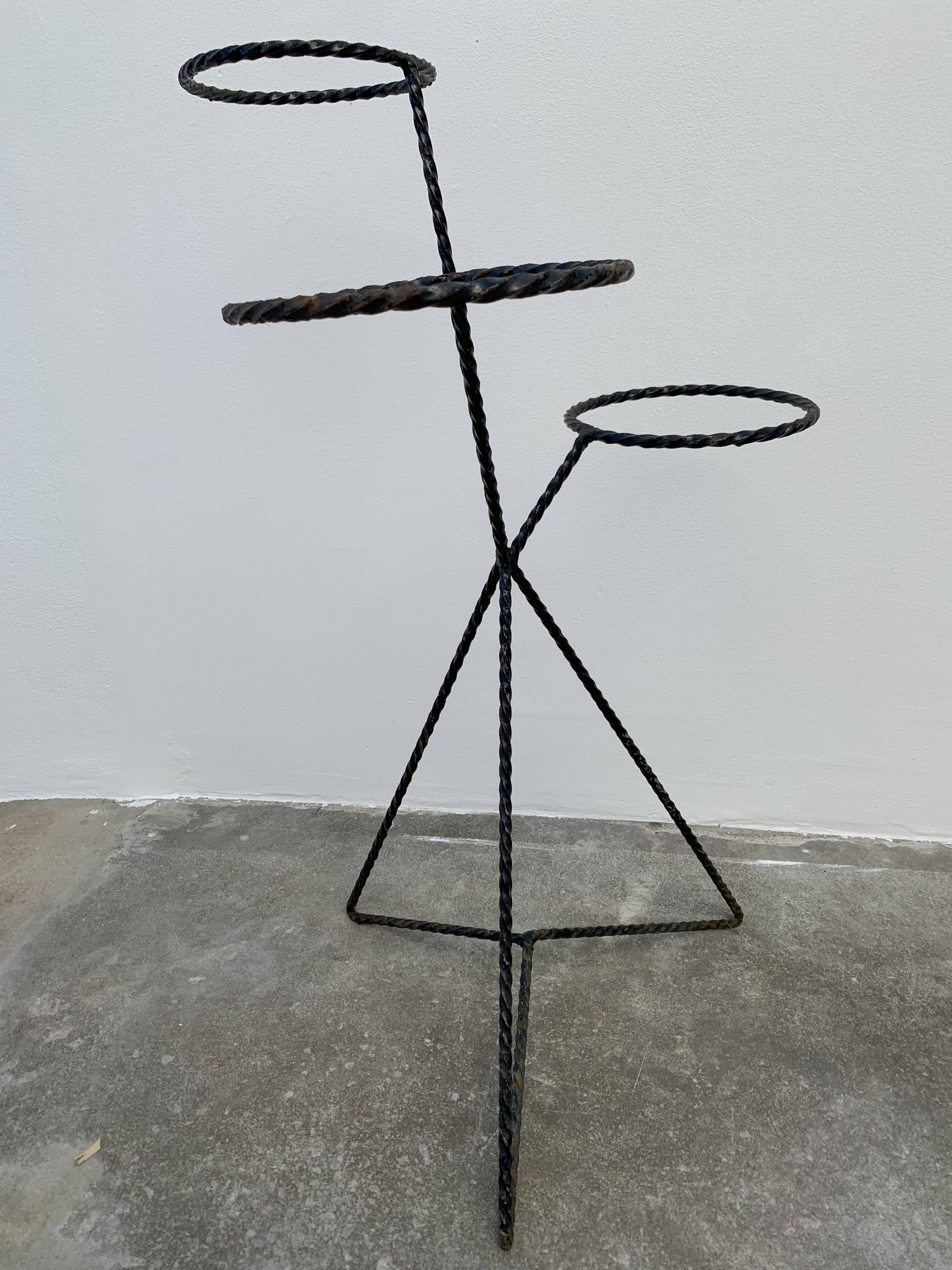 Black metal tripod plant holder