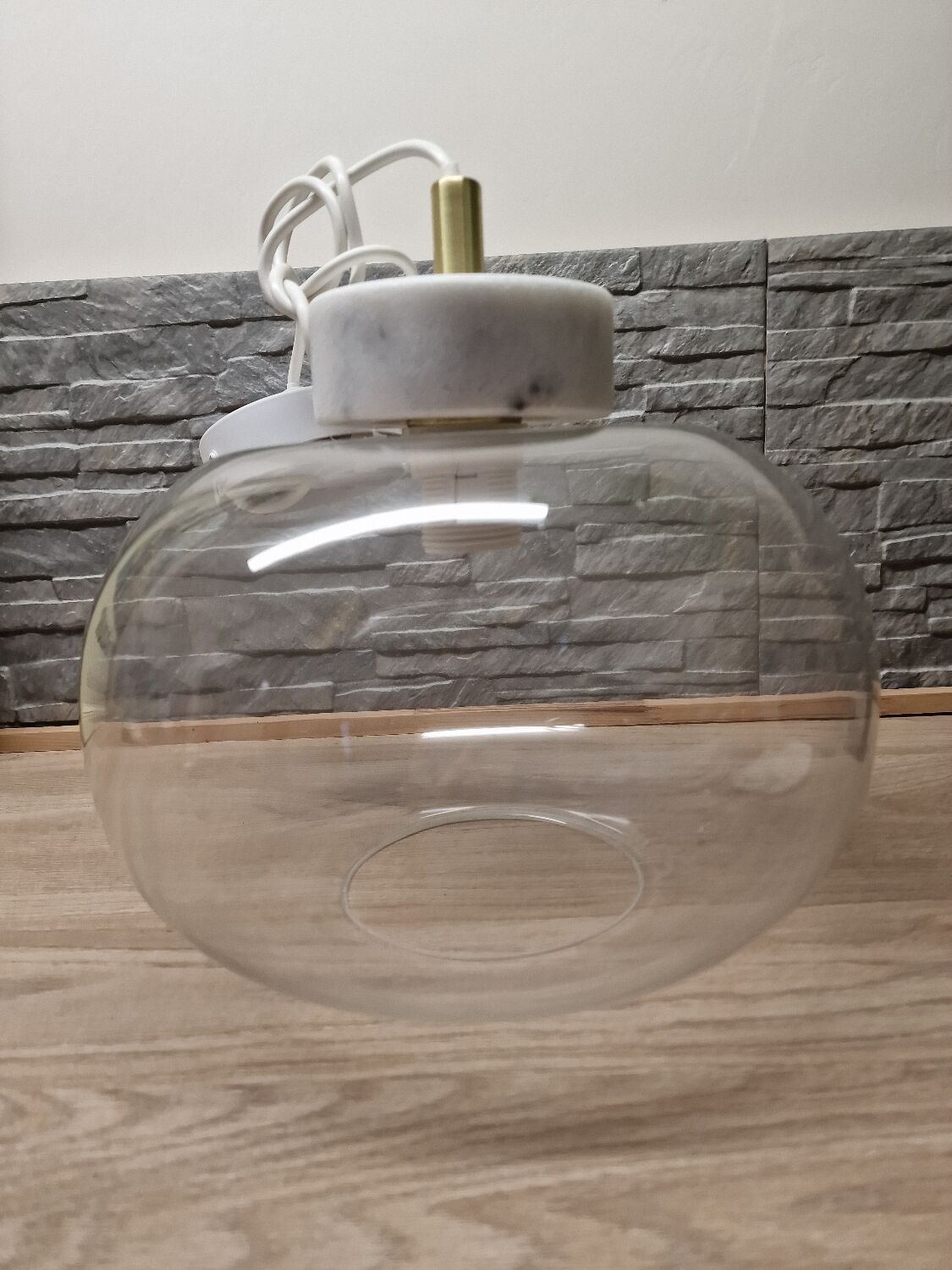 Glass globe pendant light with marble