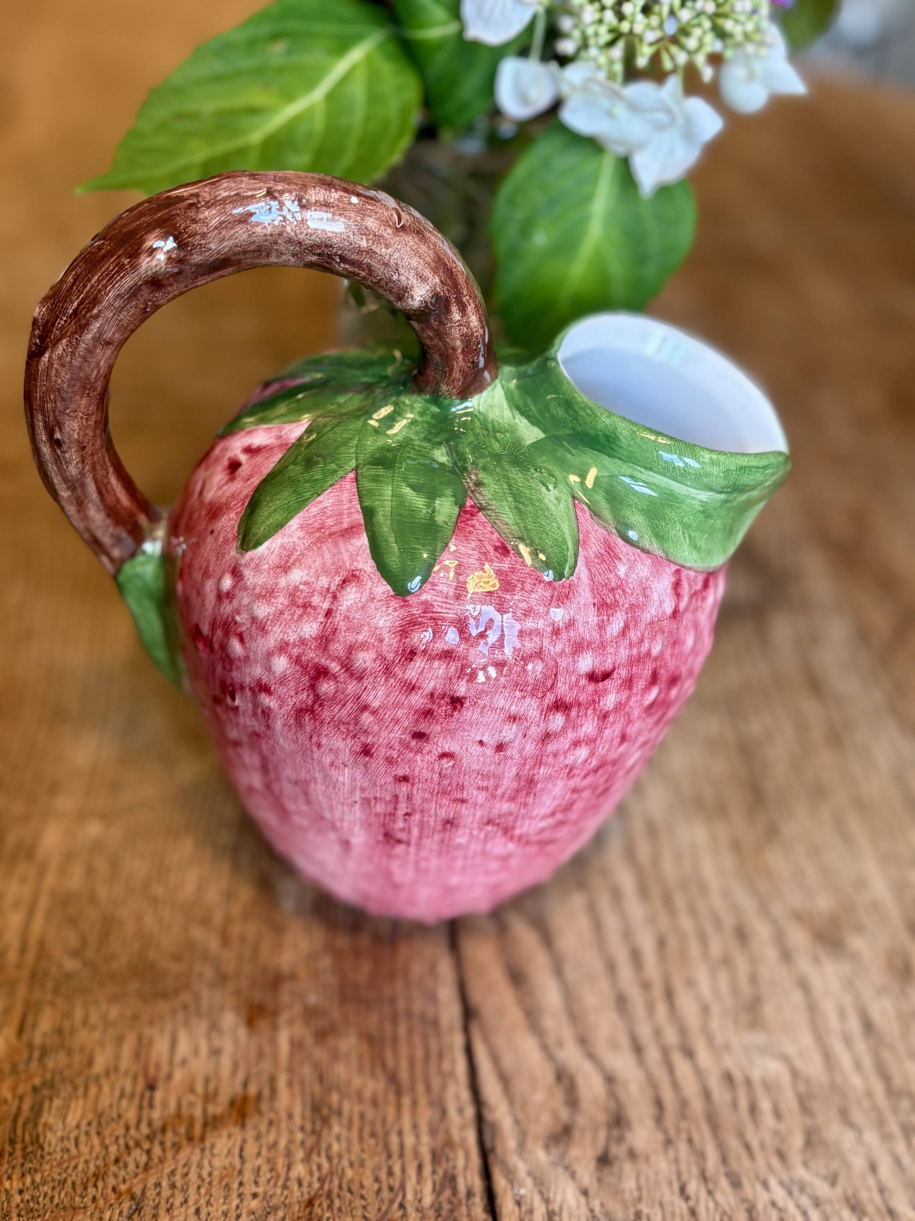 Ceramic jug in the shape of a strawberry.