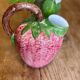 Ceramic jug in the shape of a strawberry.
