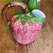 Ceramic jug in the shape of a strawberry.