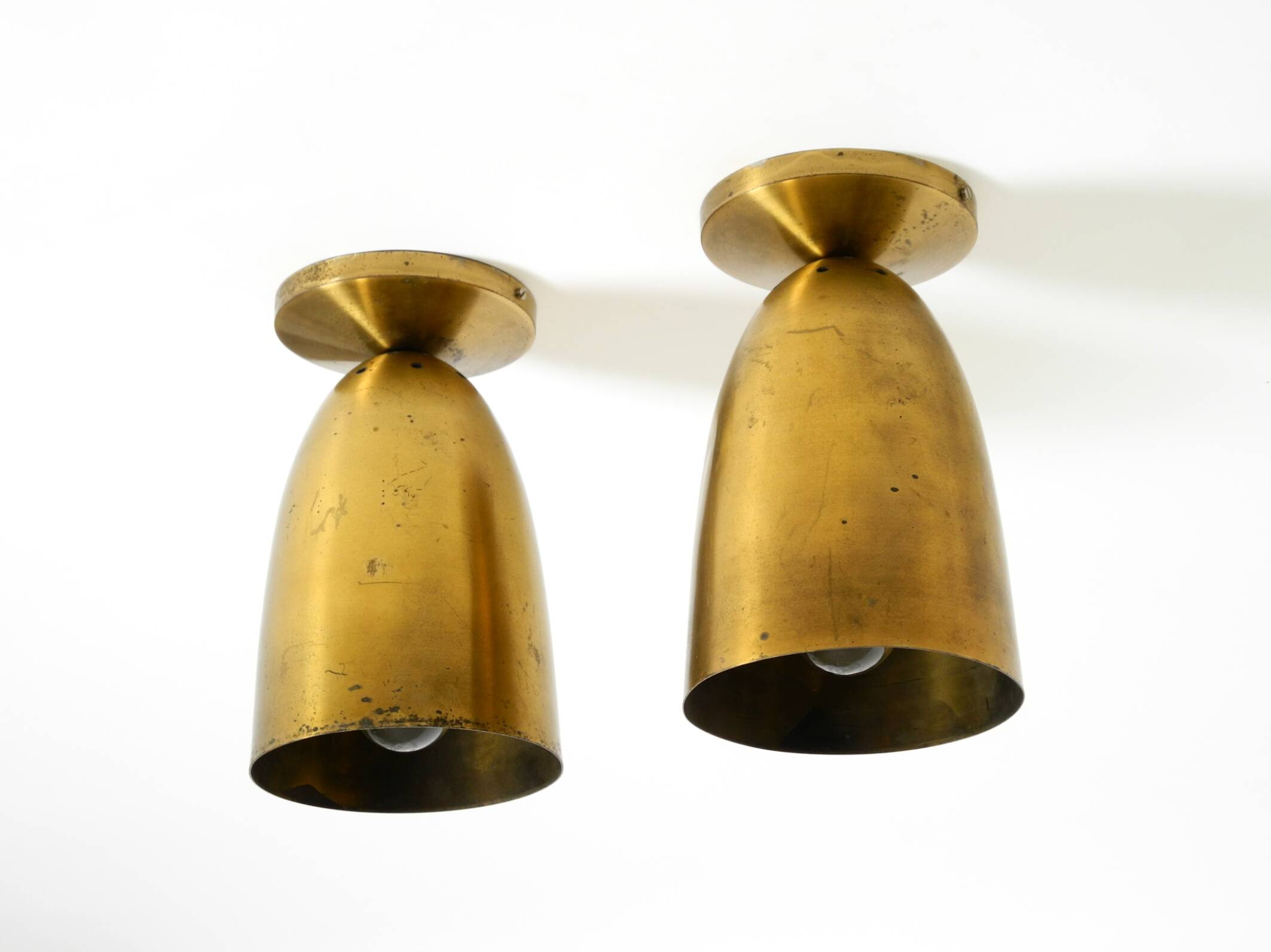 A pair of large, original Mid Century Modern brass ceiling lamps