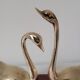 Duo of brass swans on base
