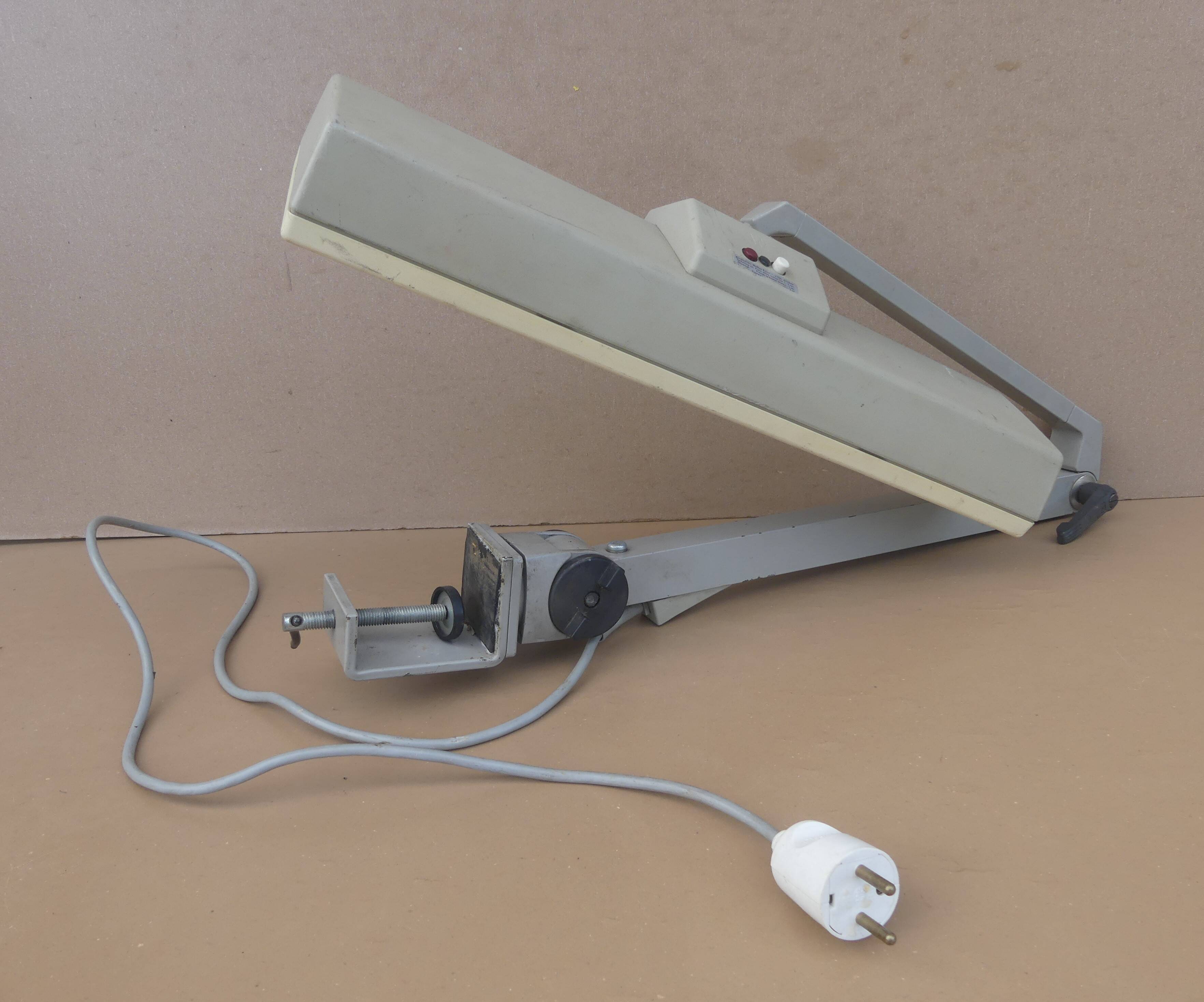 WALDMANN articulated workshop lamp with two industrial clamp arms for architects.