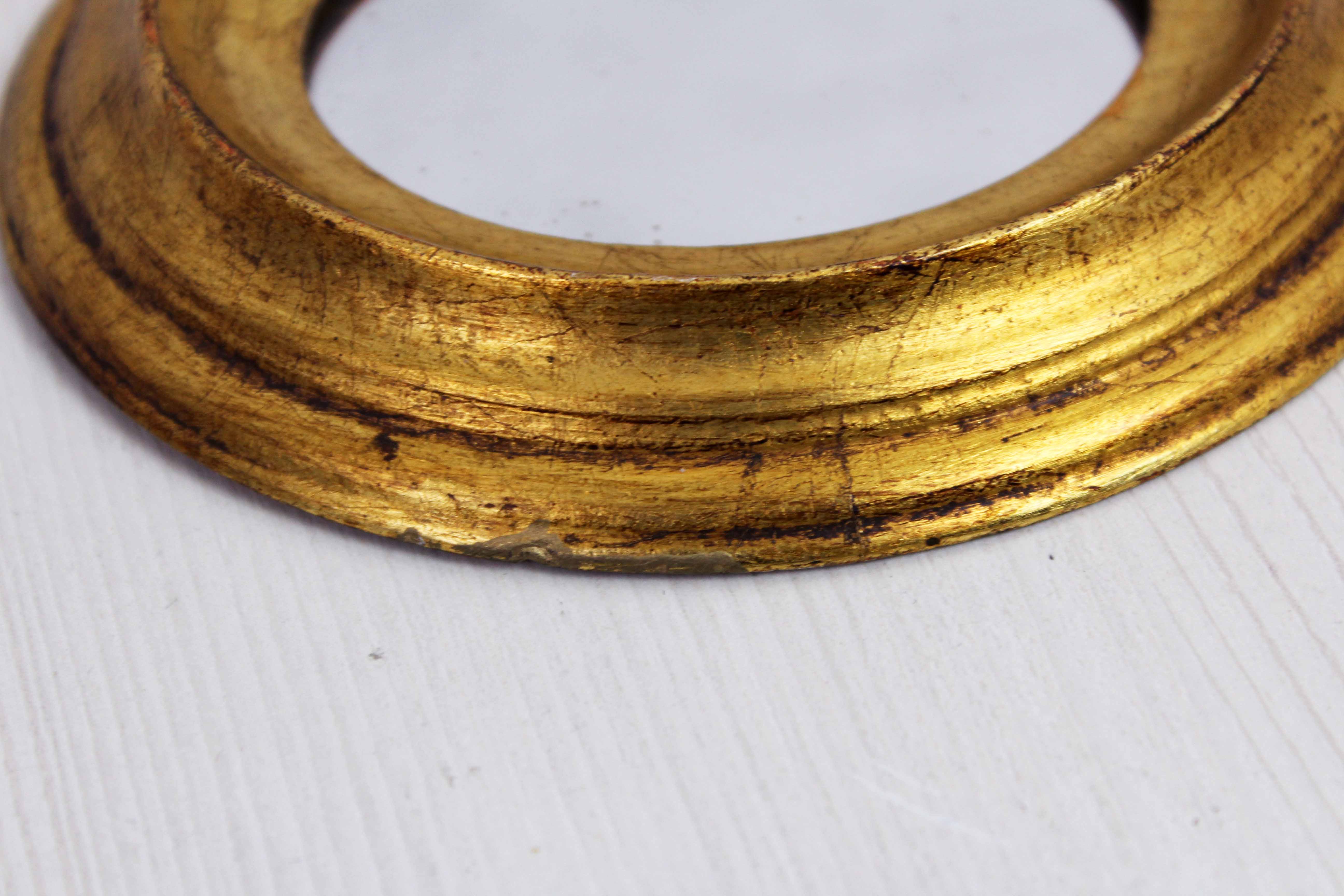 Golden oval mirror