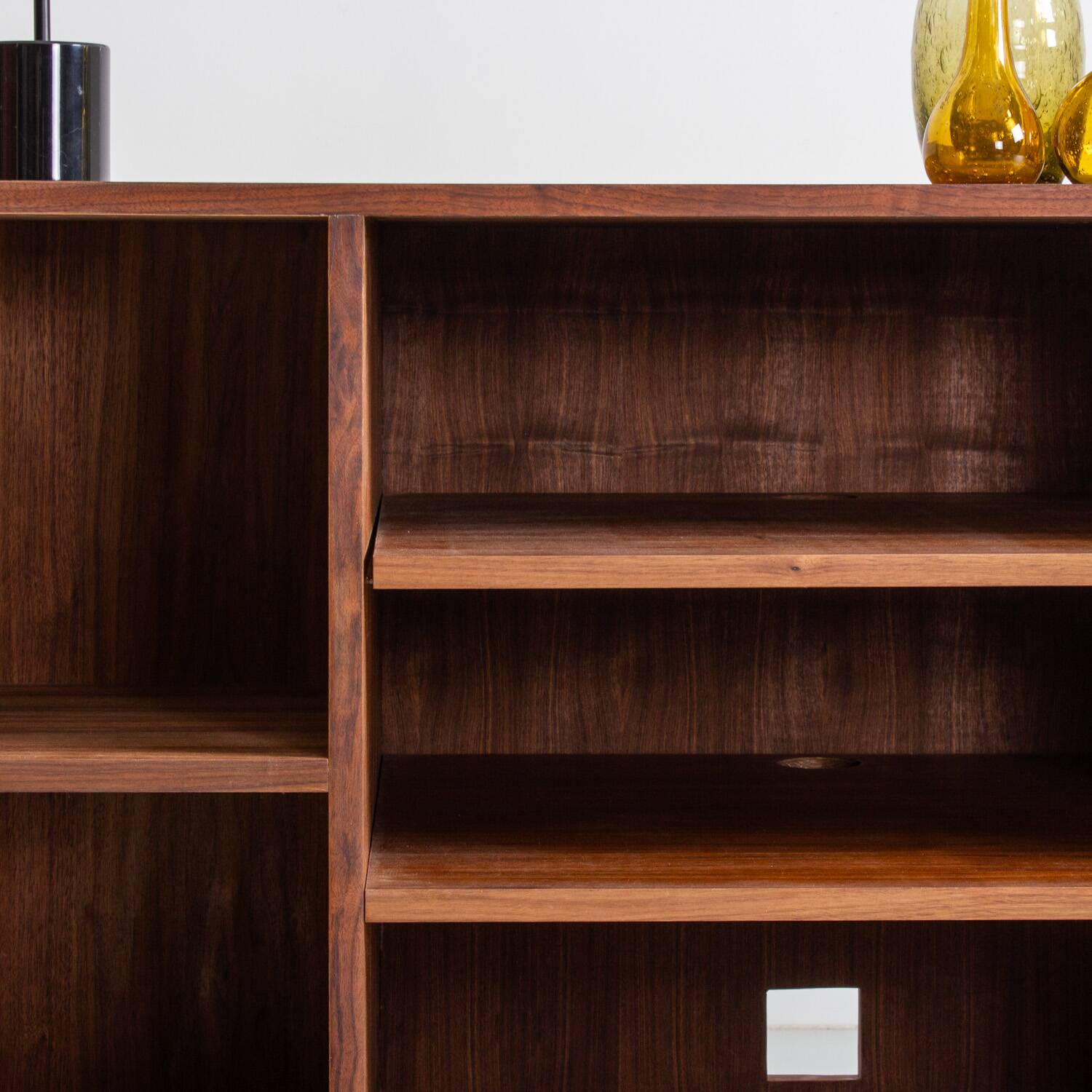Chest of drawers in walnut and black paint, solid walnut base