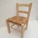 Children's chair of greige color in wood and straw