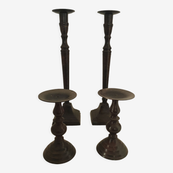 Two pairs of patinated brass candle holders