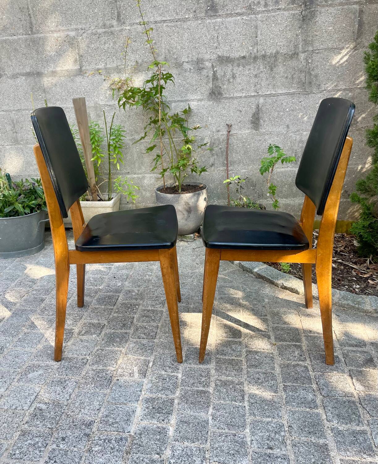Two vintage Scandinavian chairs in beech and black leatherette