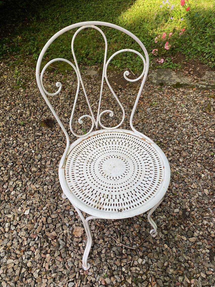 Part of a white lacquered wrought iron garden furniture set