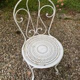 Part of a white lacquered wrought iron garden furniture set