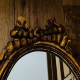 Old oval gilded stucco mirror