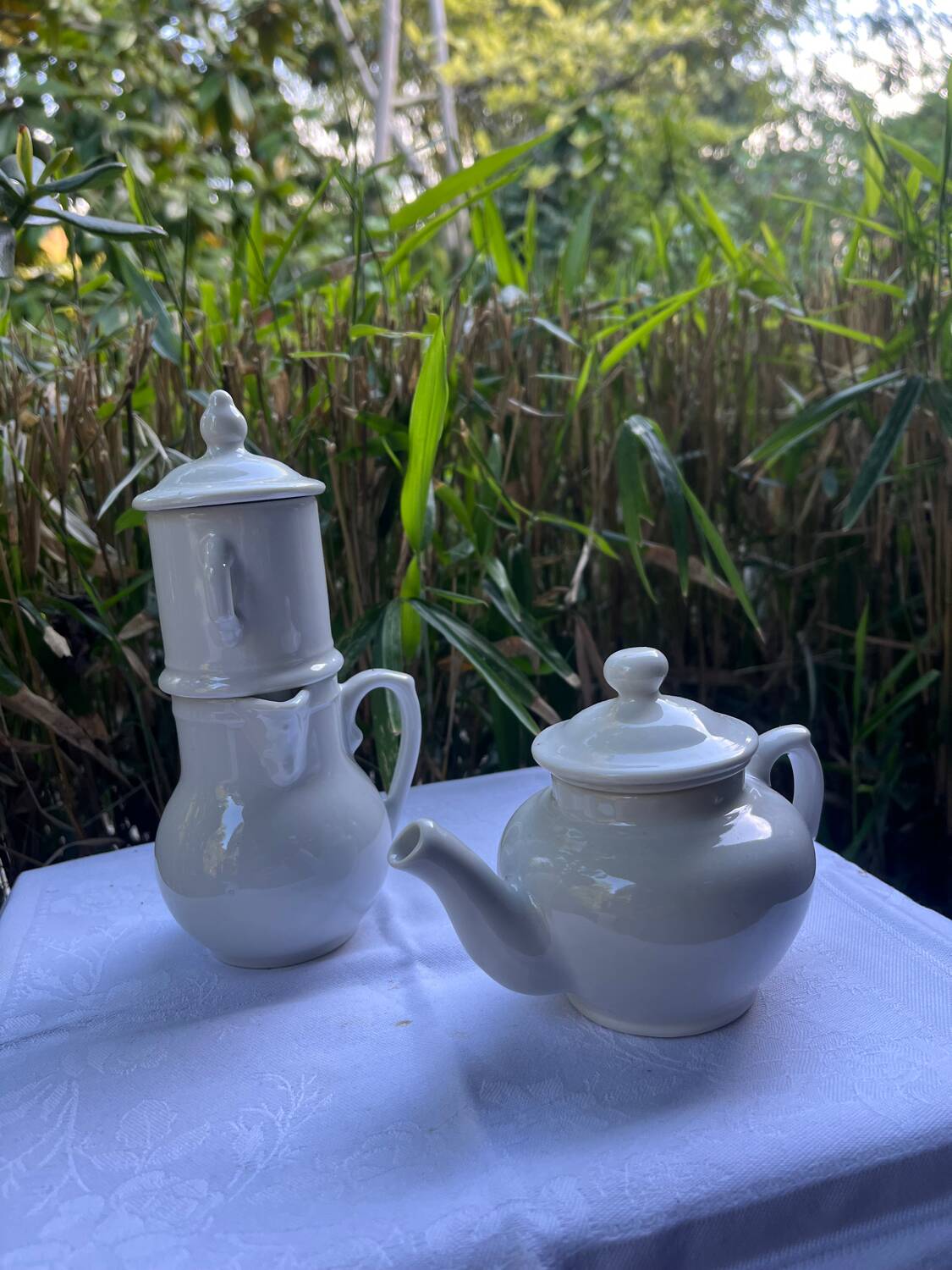 Antique white earthenware teapot, individual service with filter.