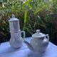 Antique white earthenware teapot, individual service with filter.