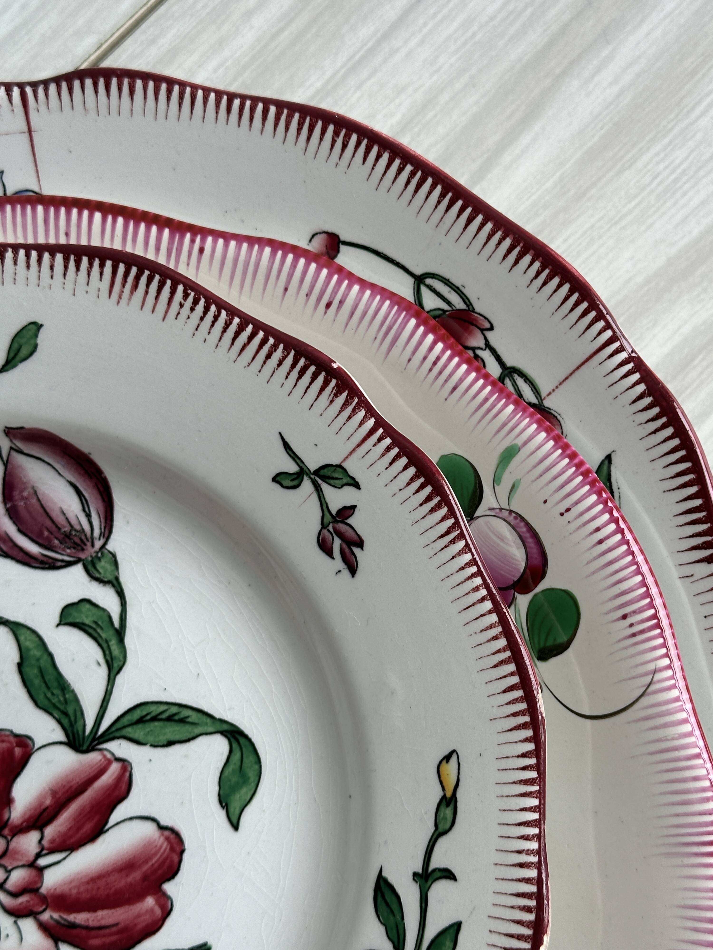 5 plates with colorful Sarreguemines floral designs.
