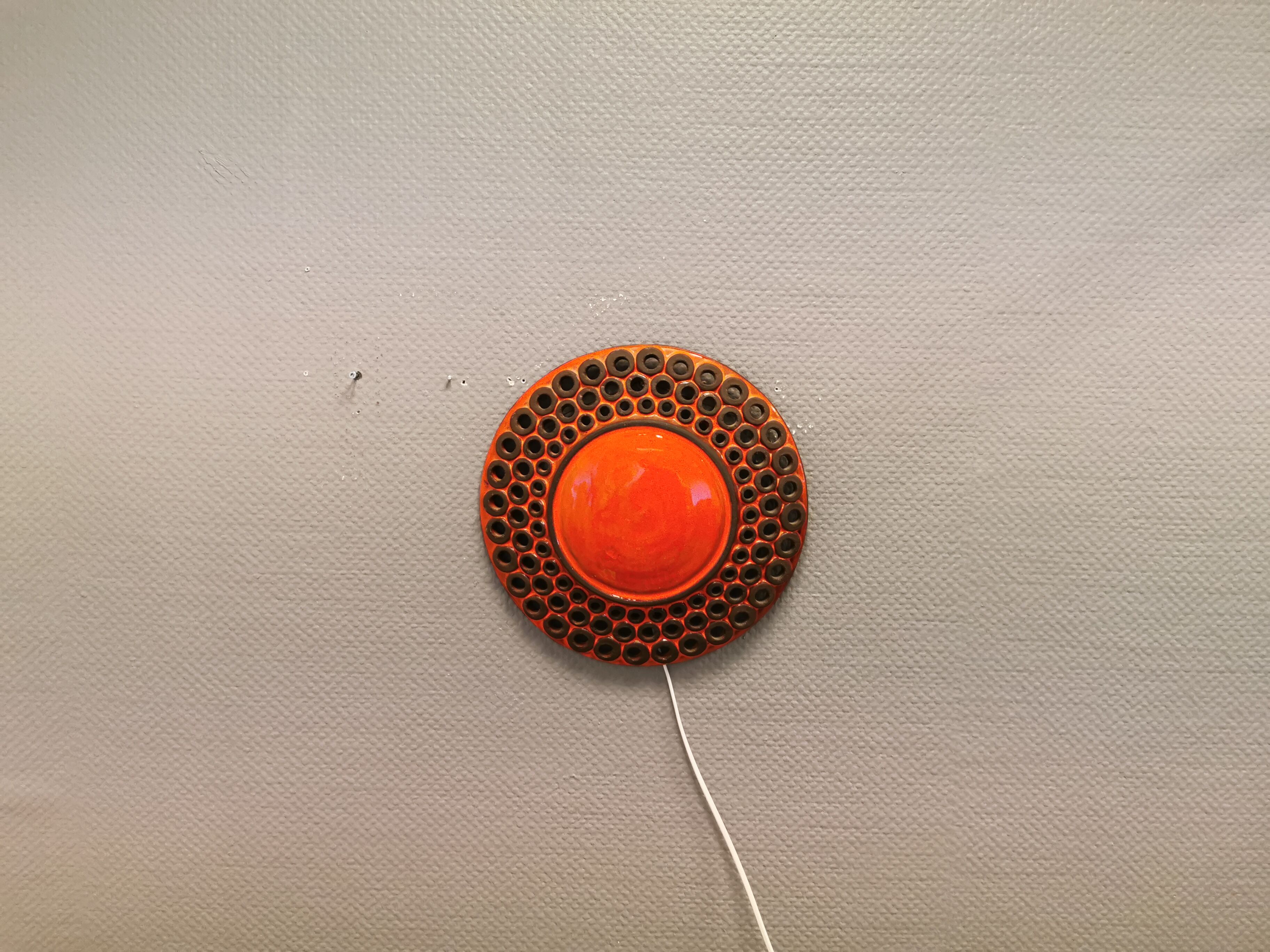 Wall light made from brown and red ceramic. Signed Norman Motala Sweden 1970s.