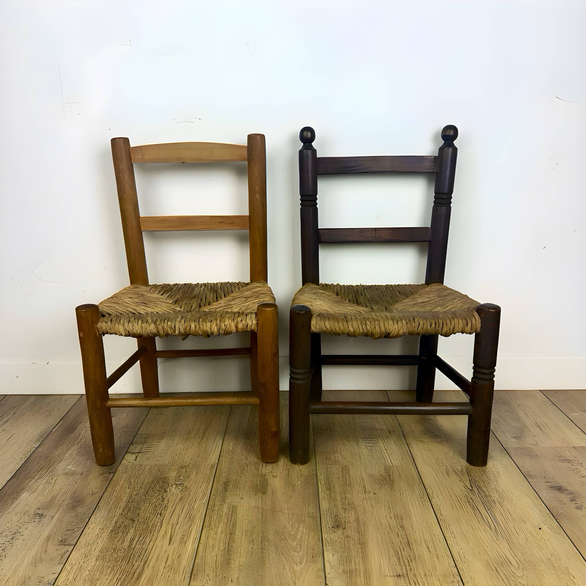 Pair of old wooden and straw children's chairs.