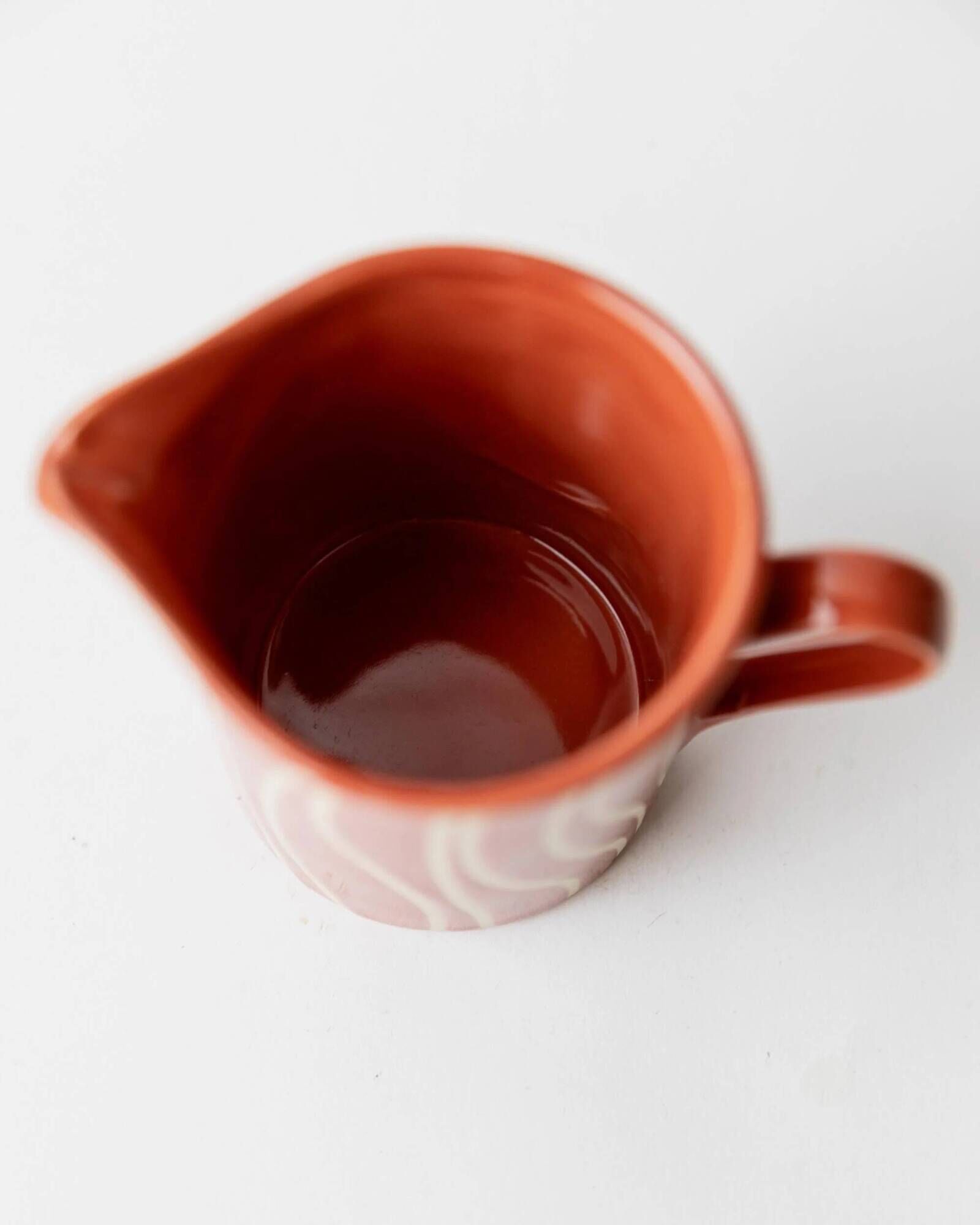 Vintage tea or coffee service in 1970s ceramic, teapot with lid and milk jug, rust orange with retro striped pattern, mid-century decoration, gift idea.