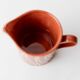 Vintage tea or coffee service in 1970s ceramic, teapot with lid and milk jug, rust orange with retro striped pattern, mid-century decoration, gift idea.