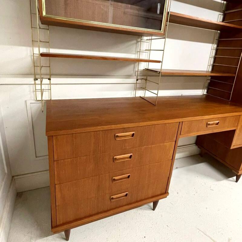 A piece of furniture combining a desk, wardrobe, and shelves.