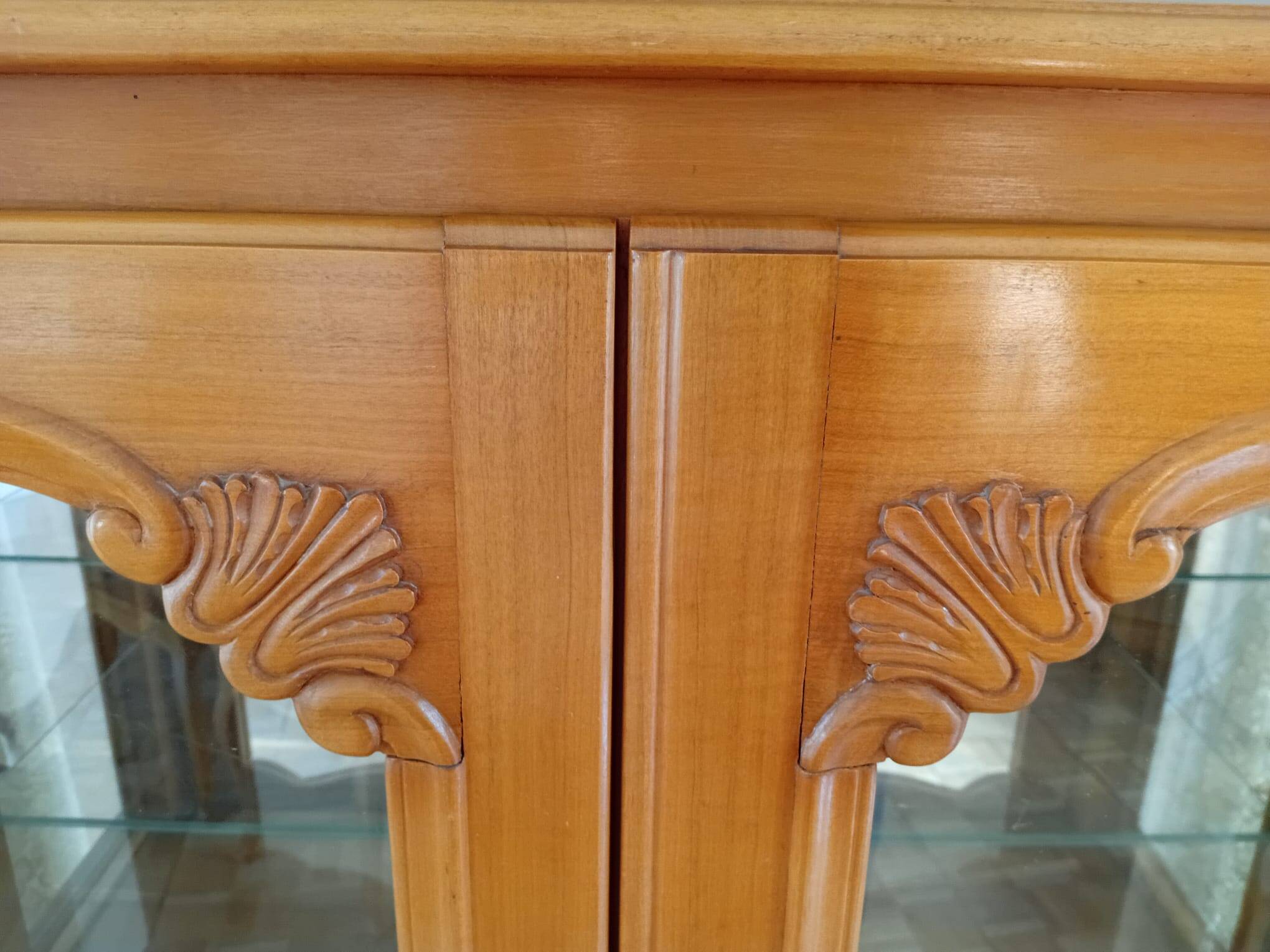 Showcase with shell mouldings in wood, glass, and mirror.