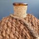 Antique amber glass bottle and hemp carrying bag