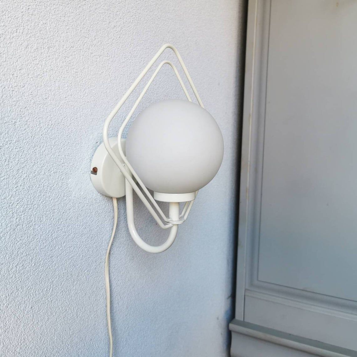 Metal applique with 80s glass sphere