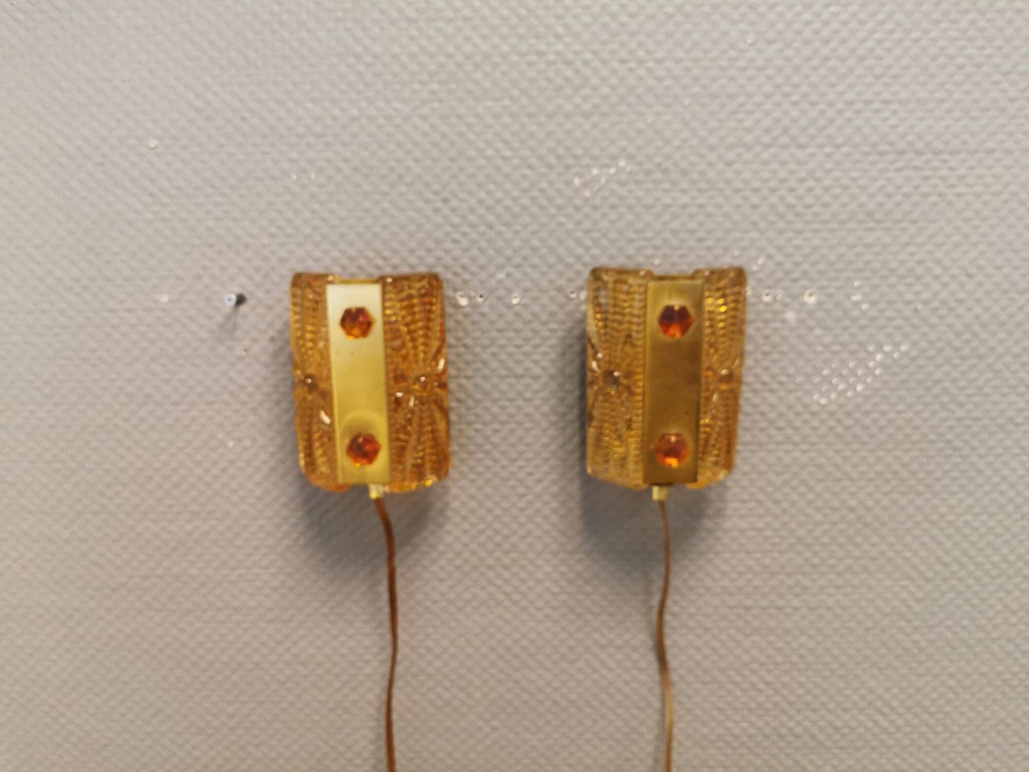 A pair of wall lights with brass-colored suspension with thick pressed glass. Vitrika, Denmark