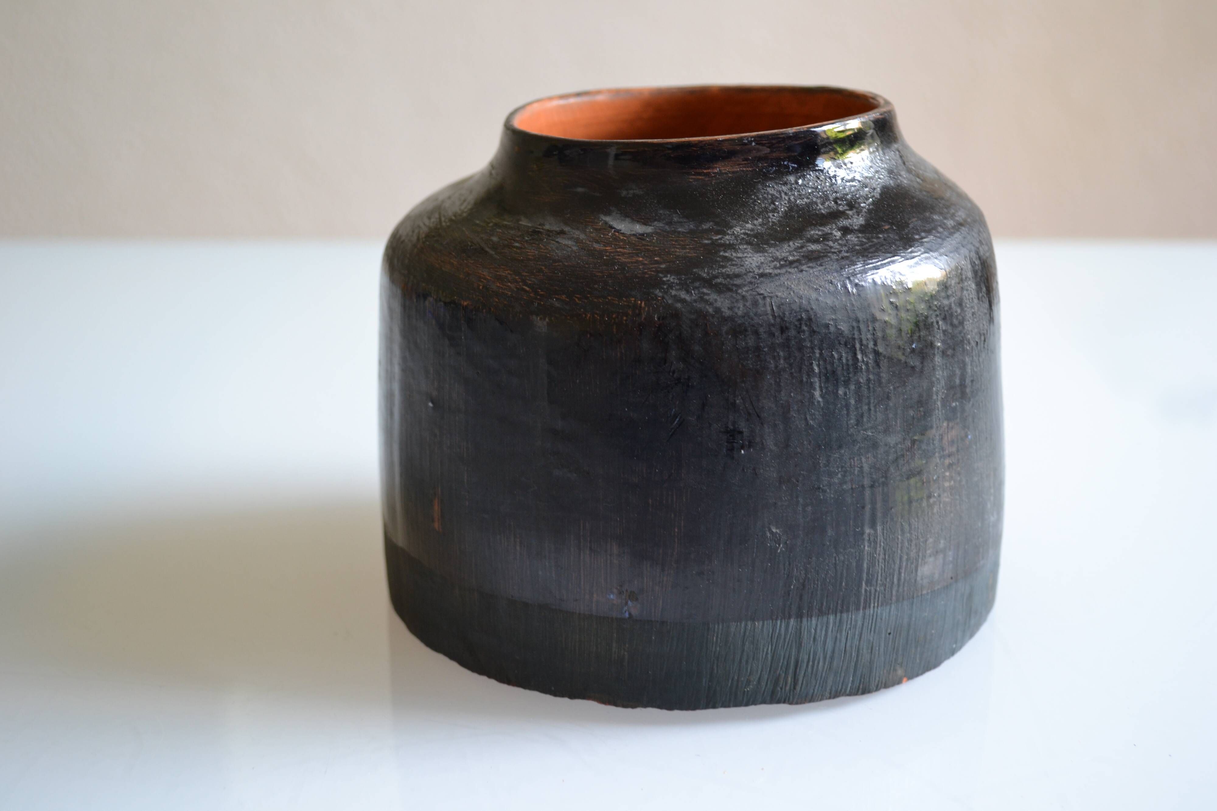 Ceramic vase with a signature fish to identify.
