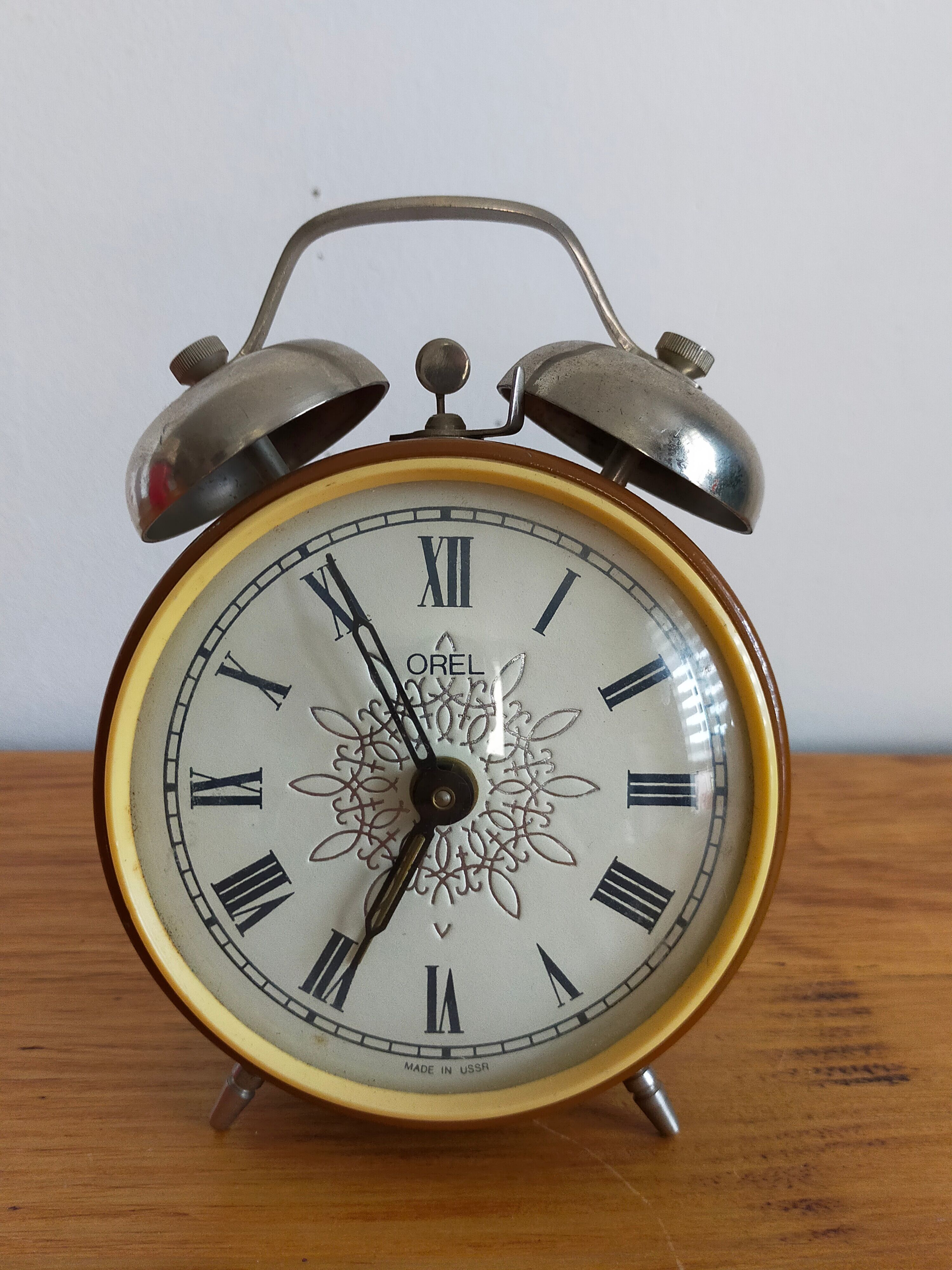 Vintage brown and silver mechanical alarm clock