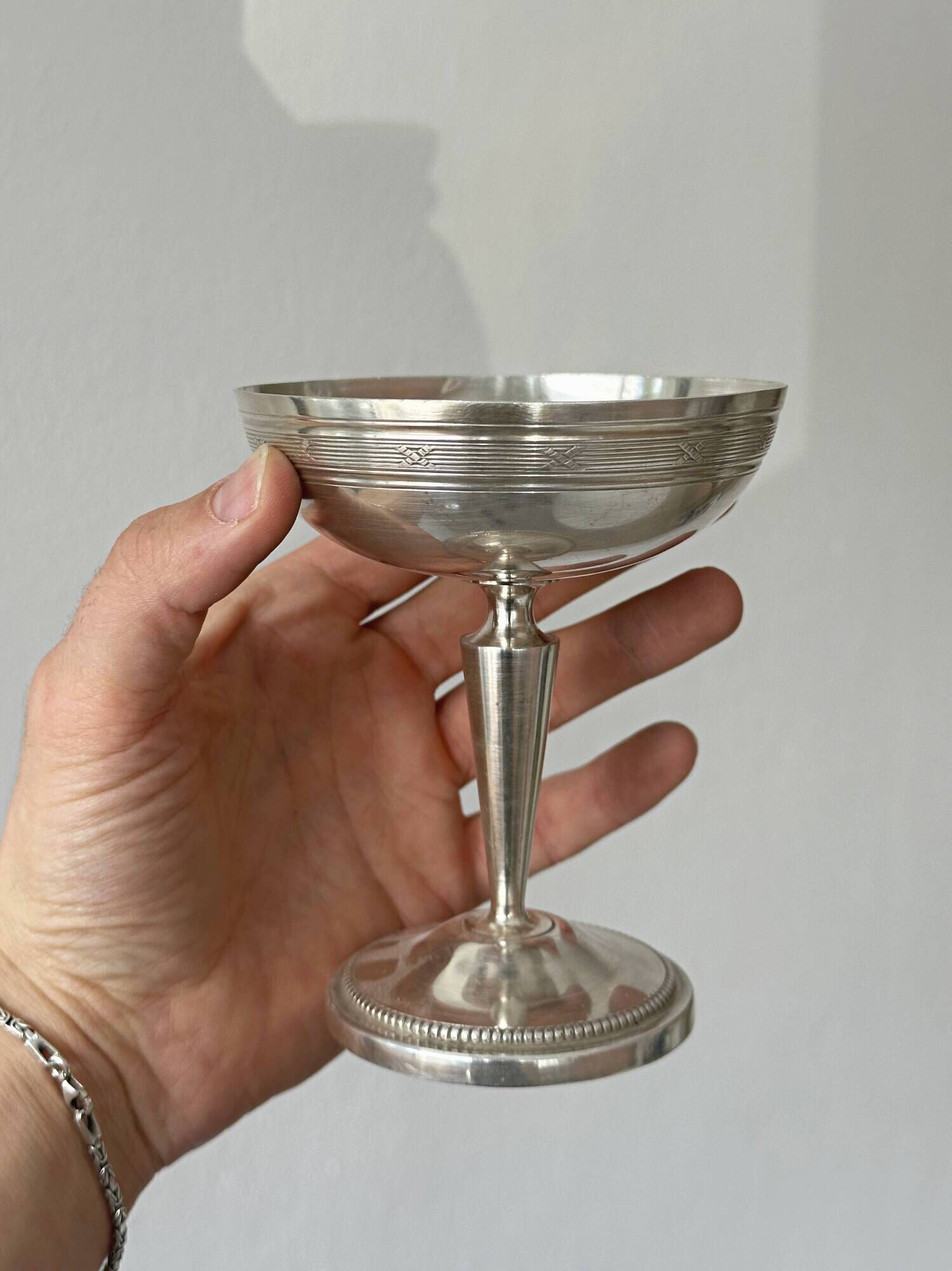 Silver-plated metal stand.