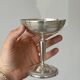 Silver-plated metal stand.
