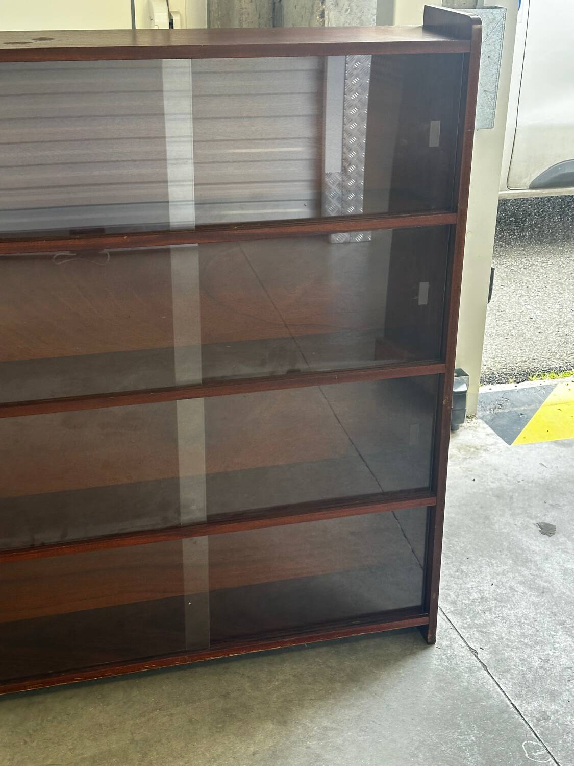 Vintage 1960s wooden library with sliding doors.