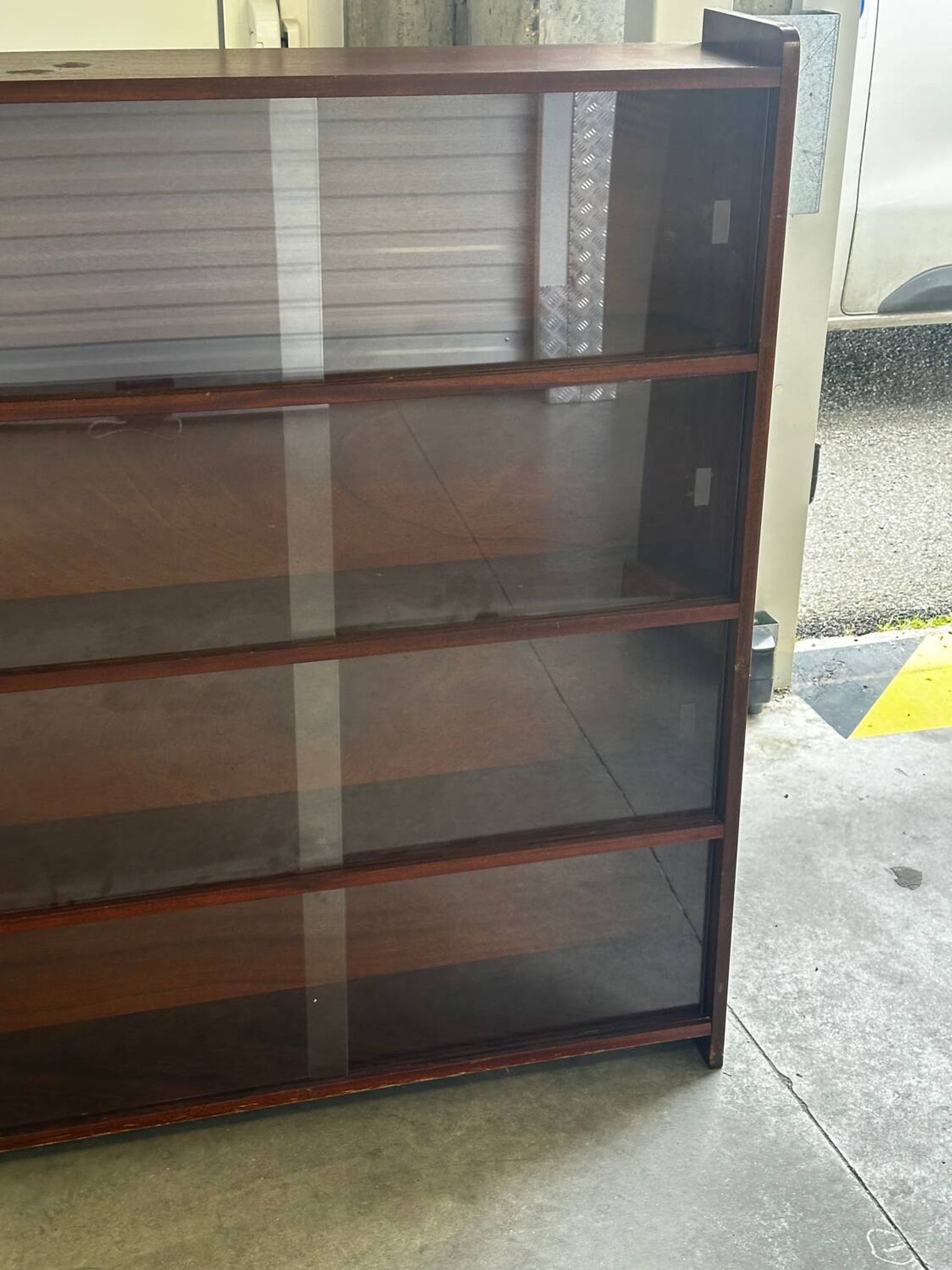 Vintage 1960s wooden library with sliding doors.
